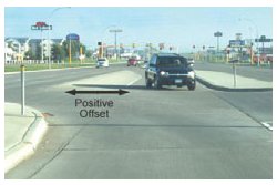 Photo of two opposing left turn lanes with a positive offset, which provides allows each left-turning motorist to see the oncoming through traffic.