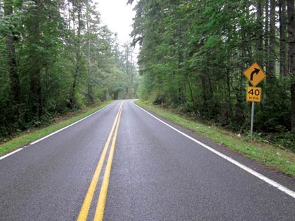 Figure 8 shows an example of enhanced signage along a two-lane curved roadway, including chevron and speed advisory signs.