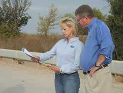 Photo: Elected offical reviewing plans with her county engineer on a rural road