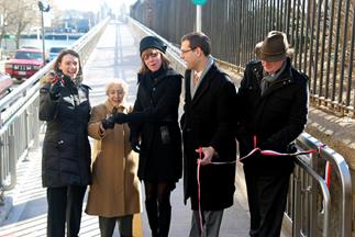 Photo: Three elected officials and two citizens cutting a ribbon for a new pedestrian bridge in Newy York City.