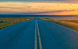 This is a photo of a two-lane rural road in a plains area.