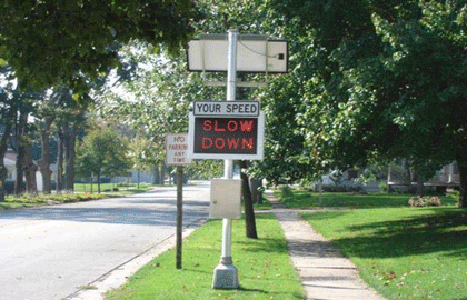 This is a photo of an automatic speed warning sign showing “SLOW DOWN” in a neighborhood area.
