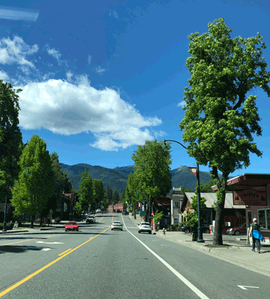This is a photo of a two-lane road going through a small rural downtown.