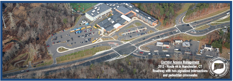 Aerial photo depicting a road segment where intersections and a shopping area have been carefully designed for safe access.