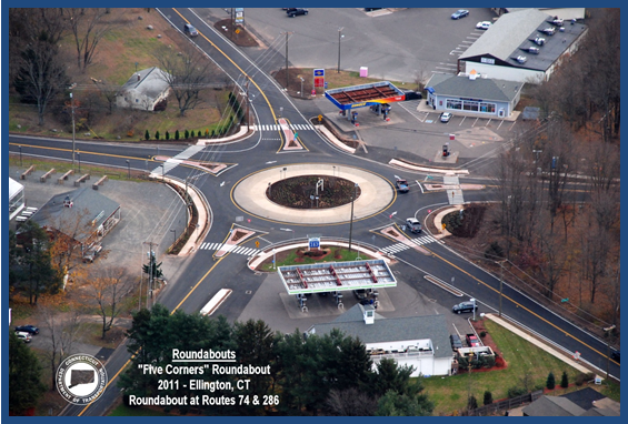 Aerial photo of a roundabout at the intersection of five different roadways. A label on the photo indicates that this is the 'Five Corners' roundabout at the intersections of Rte. 74 and 286 in Ellington, Connecticut.