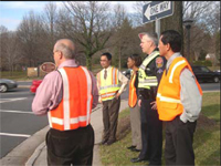 Road Safety Audit Team watching traffic signal operations and road users at an intersection