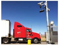 Photo of a truck being scanned at an electronic roadside inspection point.