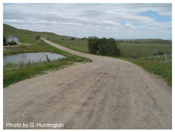 Photo of a gravel road through hilly rural country. Photo by G. Huntington.
