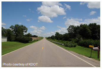 Photo of rural roadway stretching into the distance. Photo courtesy of KDOT.
