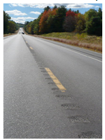 Photo of a roadway featuring centerline rumble strips.
