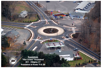Aerial photo of a roundabout at the intersection of five different roadways. A label on the photo indicates that this is the 'Five Corners' roundabout at the intersections of Rte. 74 and 286 in Ellington, Connecticut.