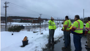 A group of people audit a snowy roadway in Bangor. Source FHWA