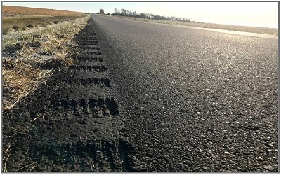 Photo shows rumble strip along a two-lane rural road in the Lake Traverse Reservation.