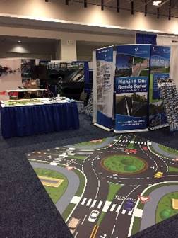 Photo depicts the floor-size roundabout decal being used at a typical trade show booth.