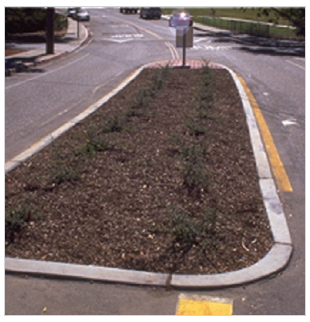 Figure 7 (bottom).  Two pictures showing curb treatments.  The picture on top shows a vertical curb around a median island; the picture on the bottom shows a sloping curb around a median island.