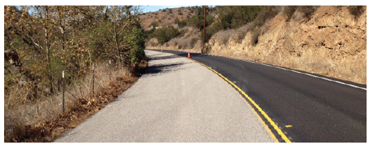 Figure 60. A picture of a horizontal curve to the left on which the approach lane has been treated with a high-friction surface treatment.