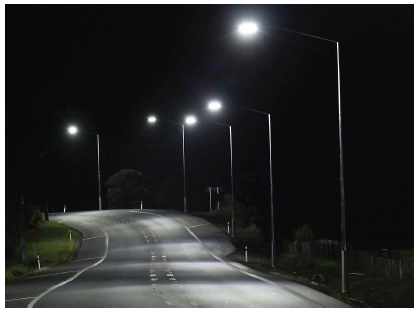 Image shows a nighttime roadway illuminated by adaptive LED road lighting