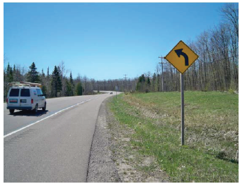 Image shows a curve delineation roadway sign