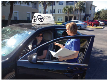 Image shows driving rehab specialists conducting an in-vehicle evaluation