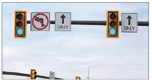 Image shows traffic signals with 12 inch signal heads and yellow retroreflective borders on backplates