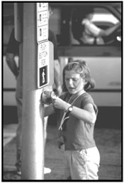 Photo: child pushing the pedestrian traffic light button