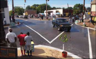 Photo: Caption: Figure 7: MemFix Temporary Intersection Improvements, Including Crosswalk Markings and Curb "Bulbouts" to Provide Safer Spaces for Pedestrians Waiting to Cross.