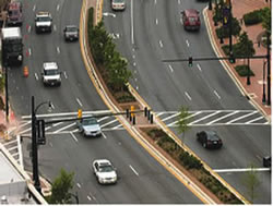 This midblock crossing in Silver Spring, Maryland uses multiple engineering strategies, including pedestrian-activated signals and a median refuge area, to improve safety for pedestrians crossing the street at this busy, urban location.