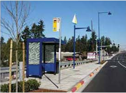 This bus stop includes a range of passenger amenities including bus stop signage, pedestrian scale lighting, a shelter and landscaping elements.