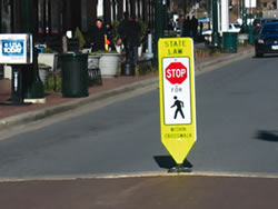 'In-roadway pedestrian crossing signs' can increase the percentage of drivers who yield to pedestrians in crosswalks.