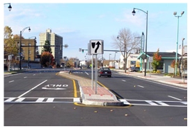 Photo of a crosswalk bisecting a raised median.