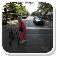 Photo: Elderly Lady Crossing Roadway Using a Walker