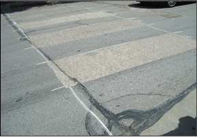 Figure 11: A street is prepared for the installation of new crosswalk in-laid markings.