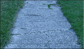 Title: Photo of cracked slabs – Description: Slabs fragmented by cracks into four or more sections, and/or where any one of the gaps is greater than 2 inches and prohibit the sidewalk from functioning as designed