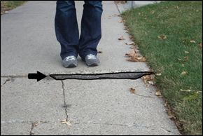 Figure 24 – Description: A small wedge may still create a hazard or be difficult to navigate in a wheelchair. This wedge had deteriorated over time.