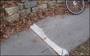 Title: Figure 25 – Description: A raised sidewalk block has been ground down to provide a smoother transition.