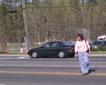 Woman crossing street, not at the intersection