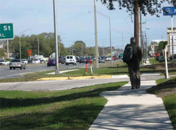Man walking on sidewalk constructed along DaleMabry Highway (SR580) in Tampa, Florida