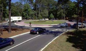 Traffic circles can be designed to accommodate large vehicles and emergency access without undue restrictions.