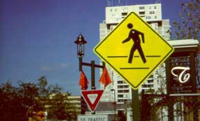 This pedestrian warning sign is fluorescent yellow green (FYG) allowing it to be more visible.