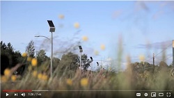 Screenshot of video shows solar devices among grass.