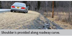 Shoulder is provided along roadway curve.