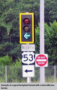Image shows a stoplight with a protected left turn light on, with a backplate framed with a retroreflective border.