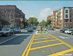 A post-treatment roadway with a pedestrian island in the middle of a buffer zone located in advance of an intersection.