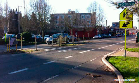 A mid-block crosswalk with a pedestrian refuge in the median. Photo: Brian Chandler