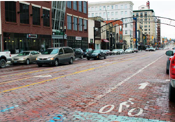 Road Diet in Flint, Michigan, central business district features a dedicated bike lane and on-street parking.
