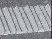 Photo.  A black and white photo of an inverted thermoplastic marker is shown.  This is similar to the raised profile, but has more raised area disrupted by inverted areas.