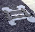 Photo.  This is a photo of a snowplowable raised pavement marker.  It is white for an edge line placement.