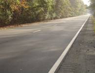 Photos.  A rumble strip to the right of an edge line.