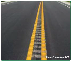Photo of center line rumble strips placed over the center line marking on a two-lane roadway. Photo: Connecticut DOT