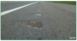 Rumble strips with shallower depth on the left and greater depth on the right.